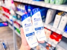 2 Head & Shoulders products held up in hair aisle at Walmart