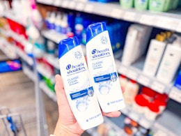 2 Head & Shoulders products held up in hair aisle at Walmart