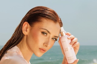 woman holding Beachwaver Co. Luxe Conditioning Detangler