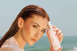 woman holding Beachwaver Co. Luxe Conditioning Detangler