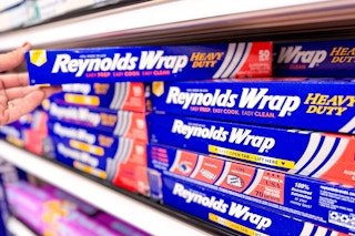hand grabbing a reynolds wrap aluminum foil off a target shelf