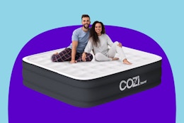Stock image of the Cozi Air Mattress in size Queen with 2 adults sitting on top