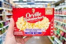 hand holding a box of orville redenbachers popcorn
