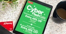An iPad displaying the JCPenney Cyber Monday 2022 advertisement on a counter with a JCPenney card, a cup of coffee, and a plant