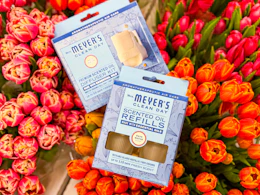 mrs meyers diffuser kit and refill sitting on top flowers