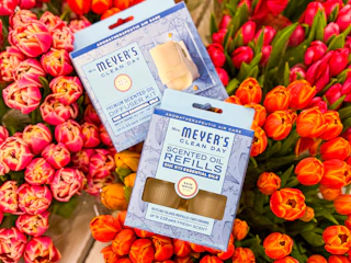 mrs meyers diffuser kit and refill sitting on top flowers