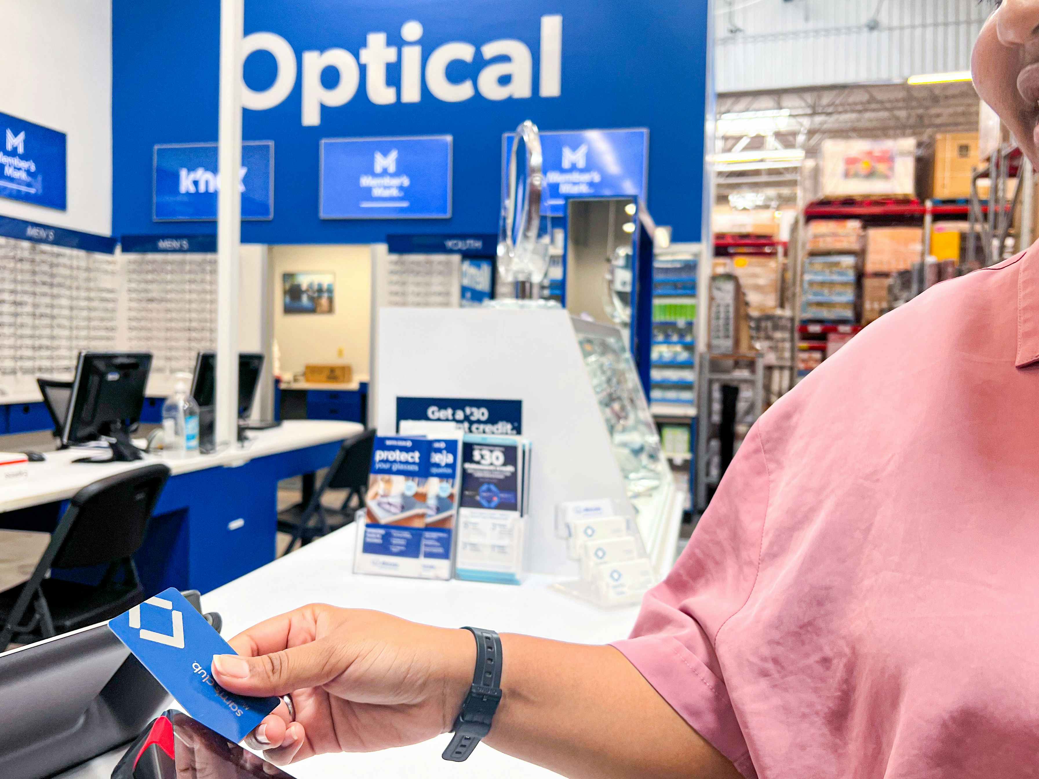 Person showing their sams club card at a point of sale system at the Optical section of Sam's Club