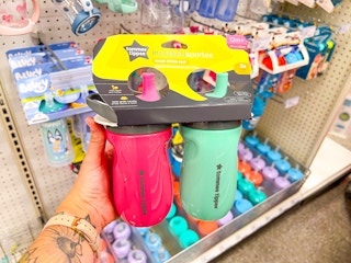 hand holding a tommee tippee toddler water bottle set at target