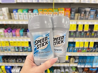 hand holding two Speed Stick deodorants