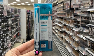 A container of L'Oreal lash serum in a store aisle