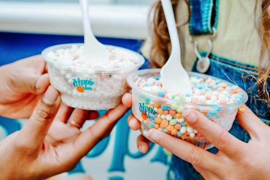 a mom and daughter holding dippin dots 