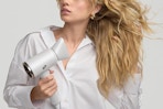 a woman using a hair dryer