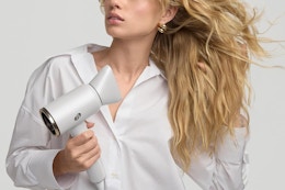 a woman using a hair dryer