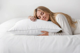 Lifestyle image of a woman sleeping on a pillow