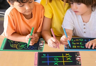 three children using lcd tablets