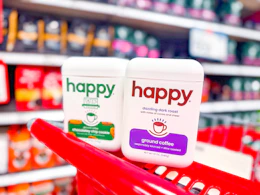 2 happy ground coffee tins sitting on top a target cart