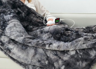 a person using a grey electric blanket