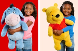 Jumbo plush toys (Eeyore & Pooh Bear from Disney's Winnie the Pooh) held by child