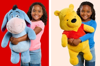 Jumbo plush toys (Eeyore & Pooh Bear from Disney's Winnie the Pooh) held by child