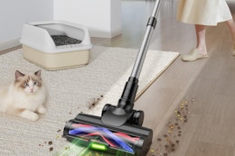 a woman using a cordless vacuum