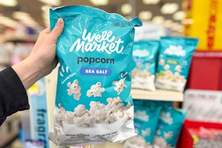 hand holding well market popcorn in cvs