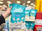 hand holding well market sea salt popcorn at cvs