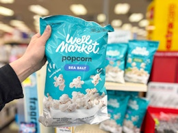 hand holding well market sea salt popcorn at cvs