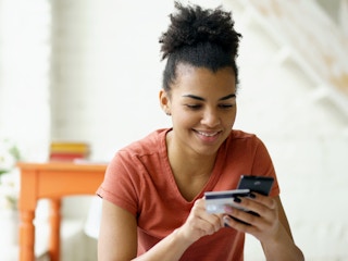 woman holding phone credit card id 106459543 1668274934 1668274934