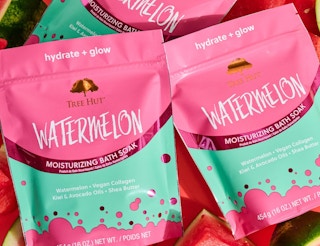 bags of watermelon bath soak on slices of watermelon