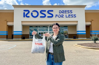 a person holding up a tj maxx bag in front of a ross sign