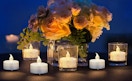 flameless tea lights on a table with flowers