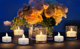 flameless tea lights on a table with flowers