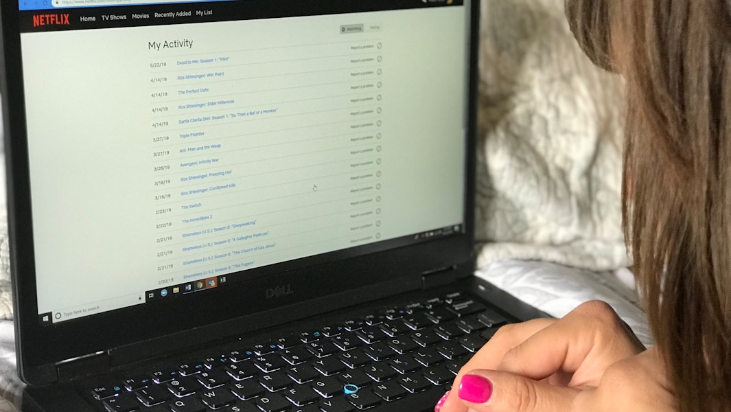 someone looking at activity on netflix on laptop