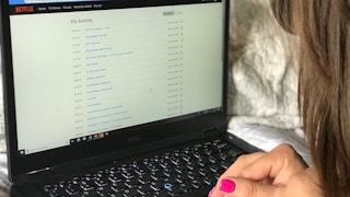 someone looking at activity on netflix on laptop