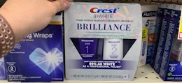 a teeth whitening toothpaste kit on a store shelf