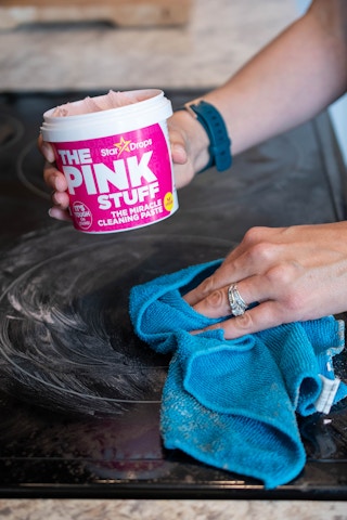 A glass cooktop stove being cleaned with Soft Scrub The Pink Stuff Cleaning Paste