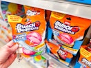 hand holding bag of bunch o balloons reusable water balloons near walmart shelf