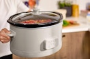 a person holding a slow cooker