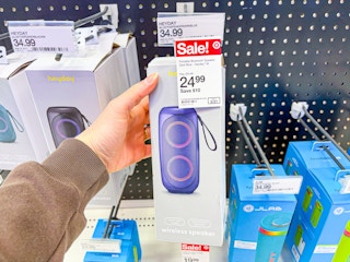 hand holding heyday bluetooth speaker behind target sale tag