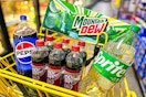mountain dew, pepsi, dr pepper, sprite in a yellow shopping cart