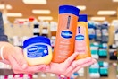 hands holding vaseline healing jelly ointment, shimmering body oil, and cocoa radiant lotion