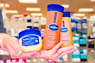 hands holding vaseline healing jelly ointment, shimmering body oil, and cocoa radiant lotion