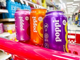 poppi soda cans sitting on top a target cart