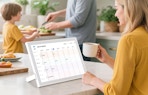 a person sitting at a table with a digital calendar
