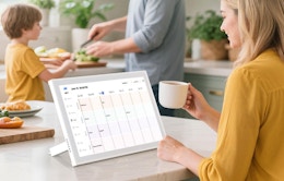 a person sitting at a table with a digital calendar
