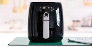 black air fryer appliance sitting on kitchen counter