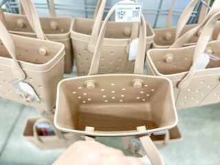 hand showing interior of time and tru mini totes at walmart