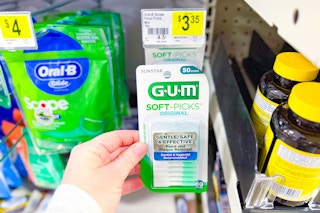 hand touching a pack of gum soft picks