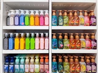 A variety of hand soaps sitting on a store shelf.