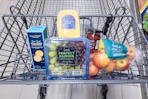 crackers, grapes, cheese, fruit spread, and apples in a cart